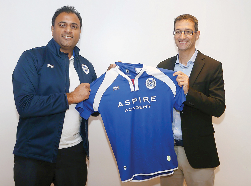 Ivan Bravo, Director General of Aspire Academy (right) receives a kit from a representative from Burrda Sport during a ceremony held at the Amsterdam ArenA, yesterday. 