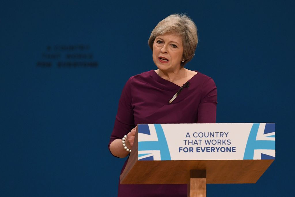 British Prime Minister Theresa delivers a keynote address on the final day of the annual Conservative Party conference at the International Convention Centre in Birmingham, central England, on October 5, 2016. / AFP / PAUL ELLIS\