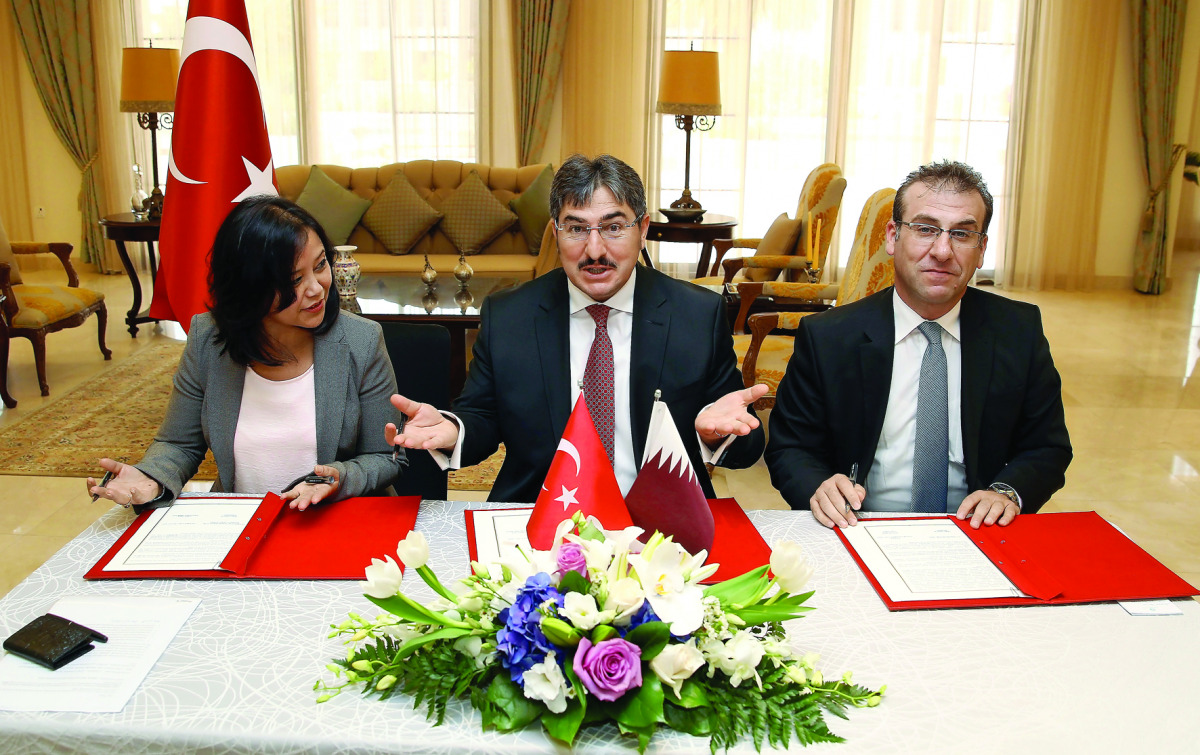 Turkish Ambassador Ahmet Demirok (centre), VFS Global Regional Head-Middle East Yummi Talwar (left) and Kingston Global Group CEO Dr. Afshin Hurmuzlu during the signing ceremony at the ambassador’s residence yesterday. Pic: Qassim Rahmatullah/The Peninsul