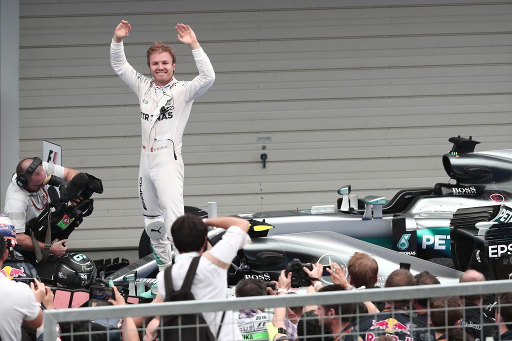 Mercedes AMG Petronas F1 Team's German driver Nico Rosberg waves whilst standing in his car after winning the Formula One Japanese Grand Prix race in Suzuka on October 7, 2016. AFP / BEHROUZ MEHRI
