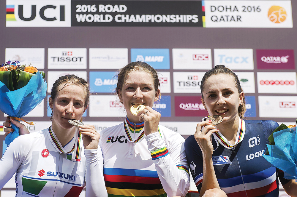 From left: Italy’s silver medallist Lisa Morzenti, gold medallist Karlijn Swinkels of the Netherlands, and France’s bronze medallist Juliette Labous celebrate on the podium at the end of the women’s junior Individual Time Trial event.