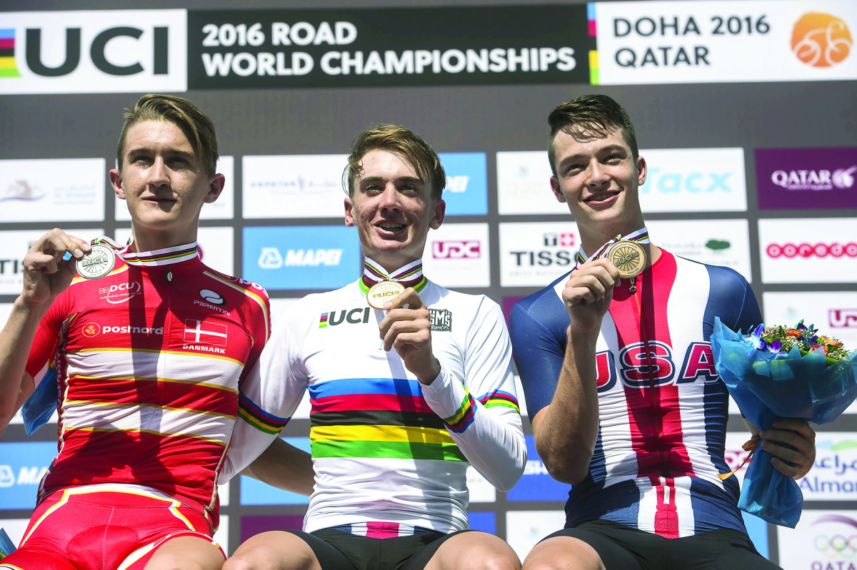 Gold medal winner Brandon Mcnulty (centre) of the US, silver medallist Mikkel Bjerg (left) of Denmark and bronze medallist Ian Garrison of the US celebrate on the podium at the end of the men’s junior individual time trial event as part of the 2016 UCI Ro