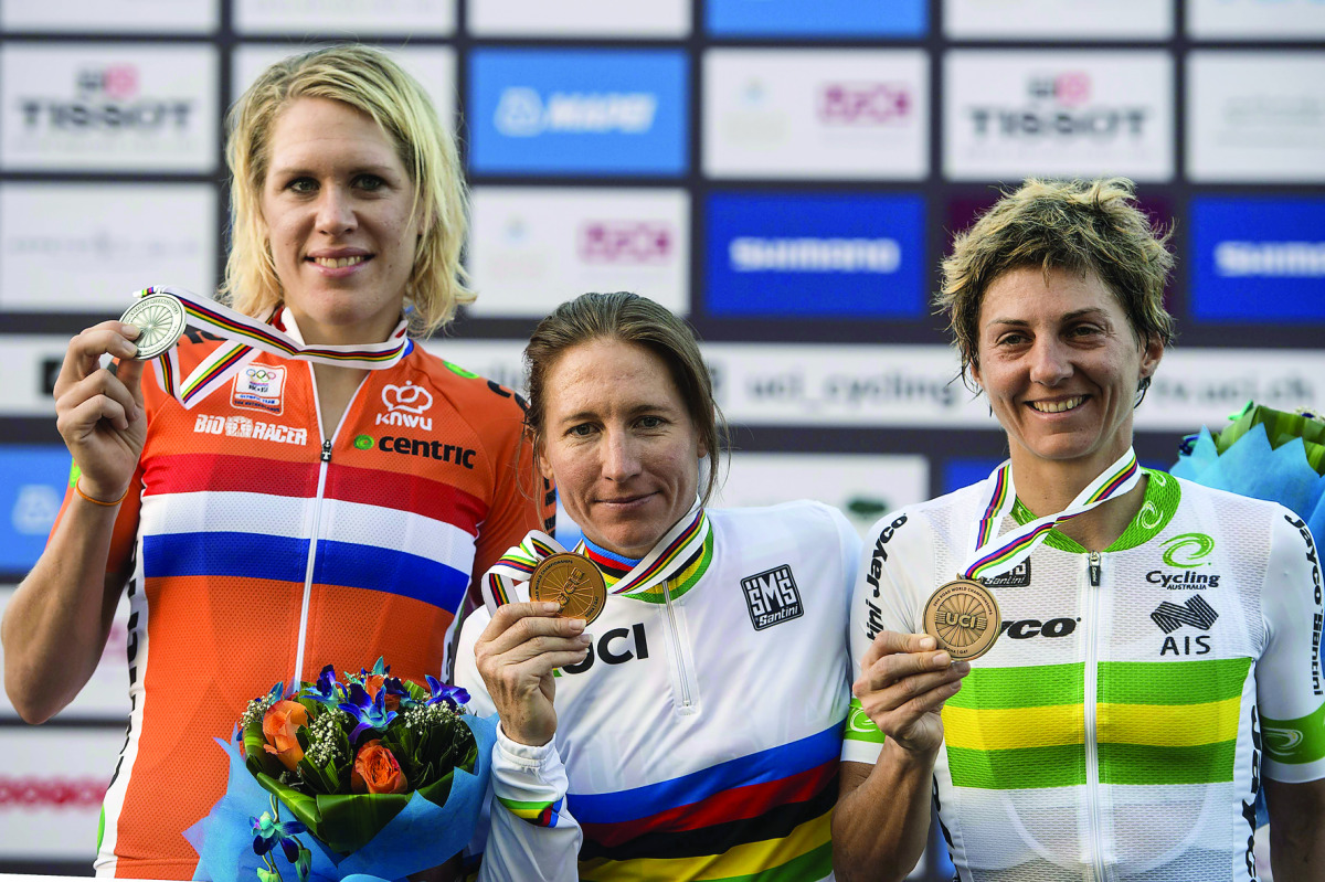 Amber Neben (centre)of the US, silver medallist Ellen van Dijk (left) of the Netherlands and bronze medallist Katrin Garfoot of Australia pose on the podium at the end of the women’s elite individual time trial event as part of the 2016 UCI Road World Cha