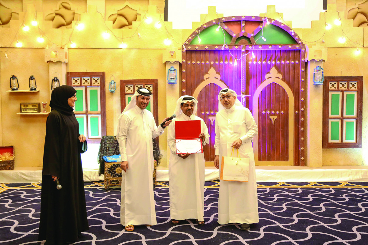 A senior citizen being honoured by the QRCS officials.