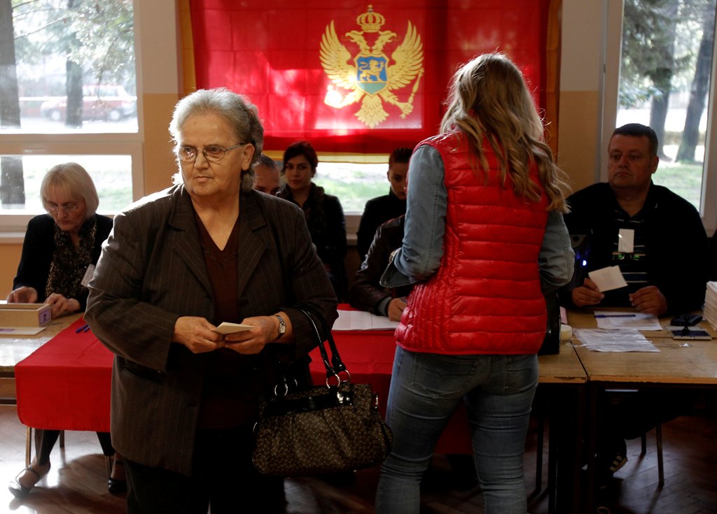 A woman prepares to vote at a polling station during the parliamentary election in Podgorica, Montenegro, October 16, 2016. REUTERS/Stevo Vasiljevic
