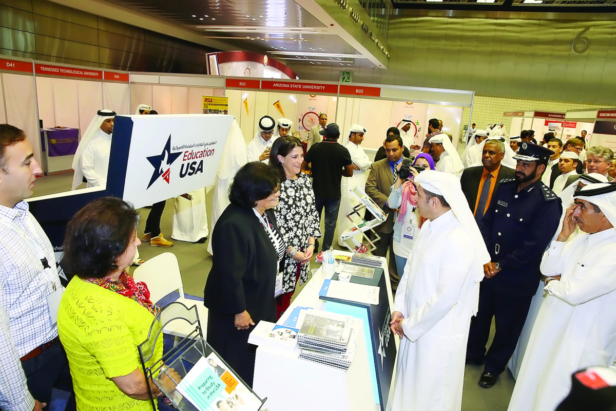 Minister of Education and Higher Education H E Dr Mohammed Abdul Wahed Ali Al Hammadi speaking to Dana Shell Smith, US Ambassador to Qatar, at the universities fair at the Qatar National Convention Center yesterday, as Student Advisor, Public Affairs Sect