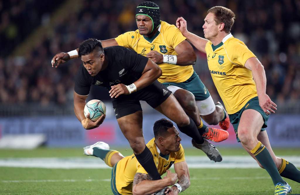 New Zealand's Julian Savea is tackled by Australia's Samu Kerevi (2nd R), Bernard Foley (R) and Israel Folau (bottom) during the third rugby Bledisloe Cup Test between the New Zealand All Blacks and Australia at Eden Park in Auckland on October 22, 2016. 