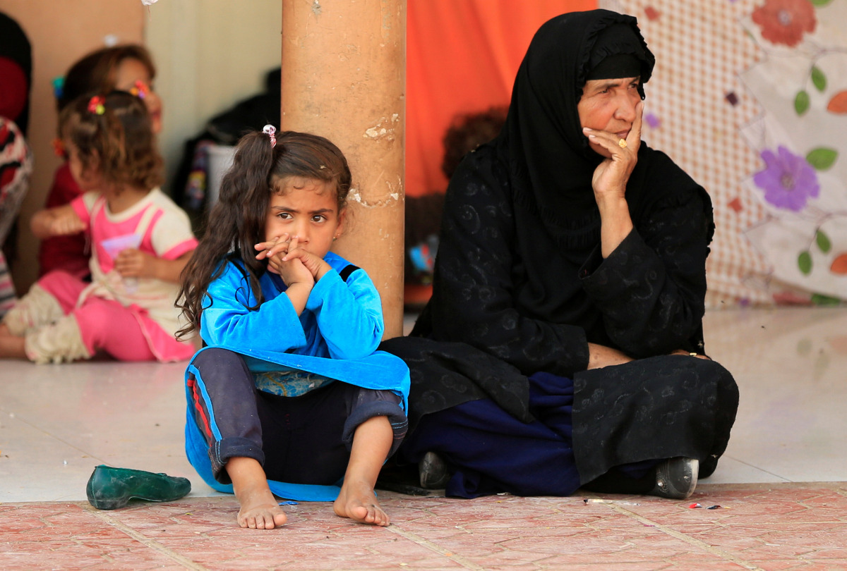 Displaced people who recently fled the Islamic State's stronghold on the outskirts of Mosul wait to be transferred to a tent, at Debaga camp on the outskirts of Erbil, Iraq October 23, 2016. (REUTERS/Thaier Al-Sudaini)
