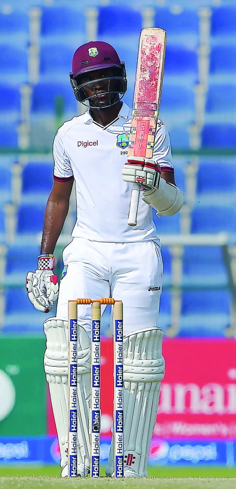 West Indies’ batsman Kraigg Brathwaite raises his bat after scoring 50 runs on the fourth day of the second Test against Pakistan at the Sheikh Zayed Cricket Stadium in Abu Dhabi, yesterday.