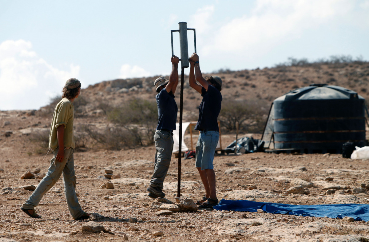 Israeli settlers start to build a new illegal outpost north of the West Bank Palestinian village of Ain al-Baida on October 25, 2016. More than 400,000 Israelis live in settlements in the occupied West Bank, considered by the international community one o