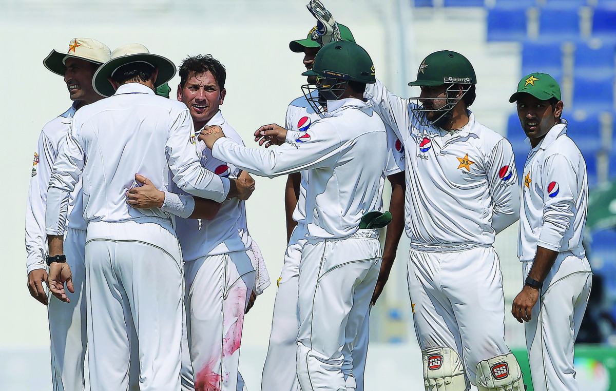 Pakistan spinner Yasir Shah (third left) celebrates with team-mates after taking the wicket of the West Indies’ captain Jason Holder (unseen) on the final day of the second Test at the Sheikh Zayed Cricket Stadium in Abu Dhabi yesterday.