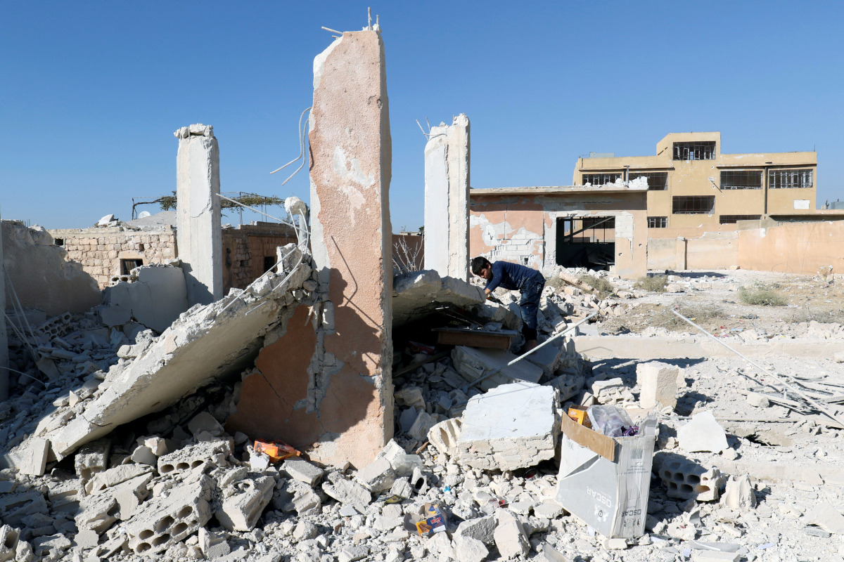 A boy inspects a damaged site after shelling in the rebel held town of Hass, south of Idlib province, Syria October 26, 2016. (REUTERS/Ammar Abdullah)