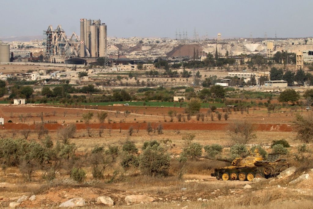 A general view shows an abandoned tank near a cement factory in the government-held Sheikh Said area on the southern outskirts of the northern embattled Syrian city of Aleppo, as Syrian government forces advance in the ongoing offensive to seize the rebel