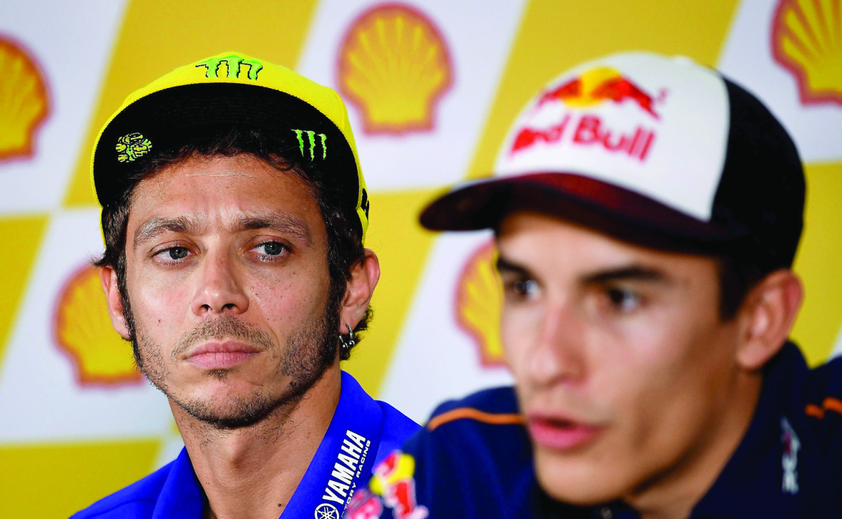 Movistar Yamaha MotoGP’s Italian rider Valentino Rossi (left) looks on as Repsol Honda Team’s Spanish rider Marc Marquez addresses a press conference ahead of the 2016 MotoGP Malaysian Grand Prix at Sepang International Circuit in Sepang, Malaysia, yester