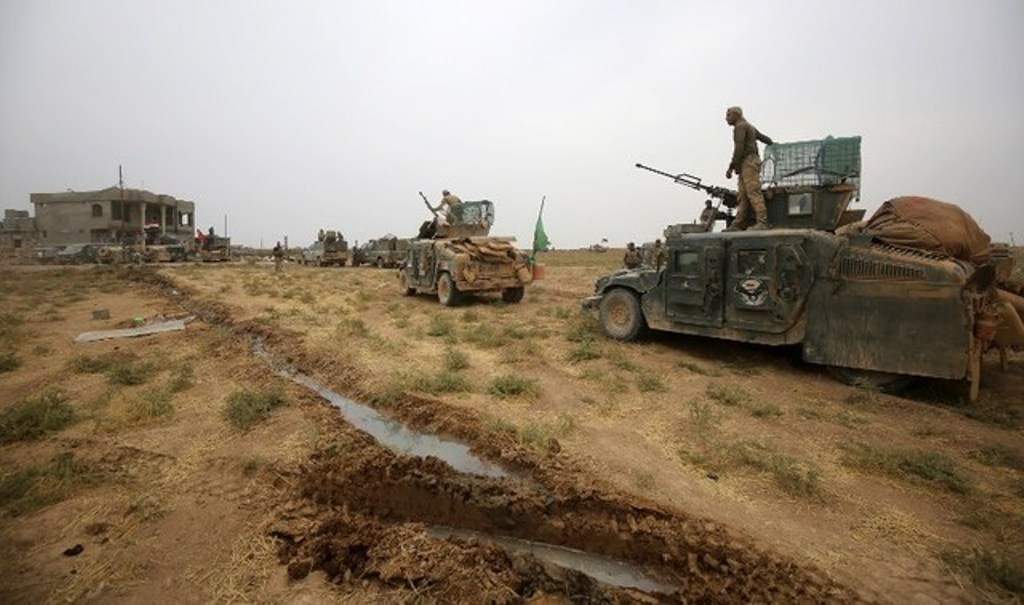 OPERATION. Iraqi forces wait on their vehicles in the village of Umm Mahahir, south of Mosul, on October 28, 2016 after they recaptured it from the Islamic State (IS) group jihadists as part of their operation to retake the main hub city of Mosul. Ahmad A