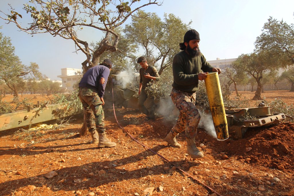 A rebel fighter carries an empty smoking shell in Dahiyet al-Assad after firing towards Regime-held Hamdaniyah neighbourhood, west Aleppo city, Syria October 30, 2016. REUTERS/Ammar Abdullah