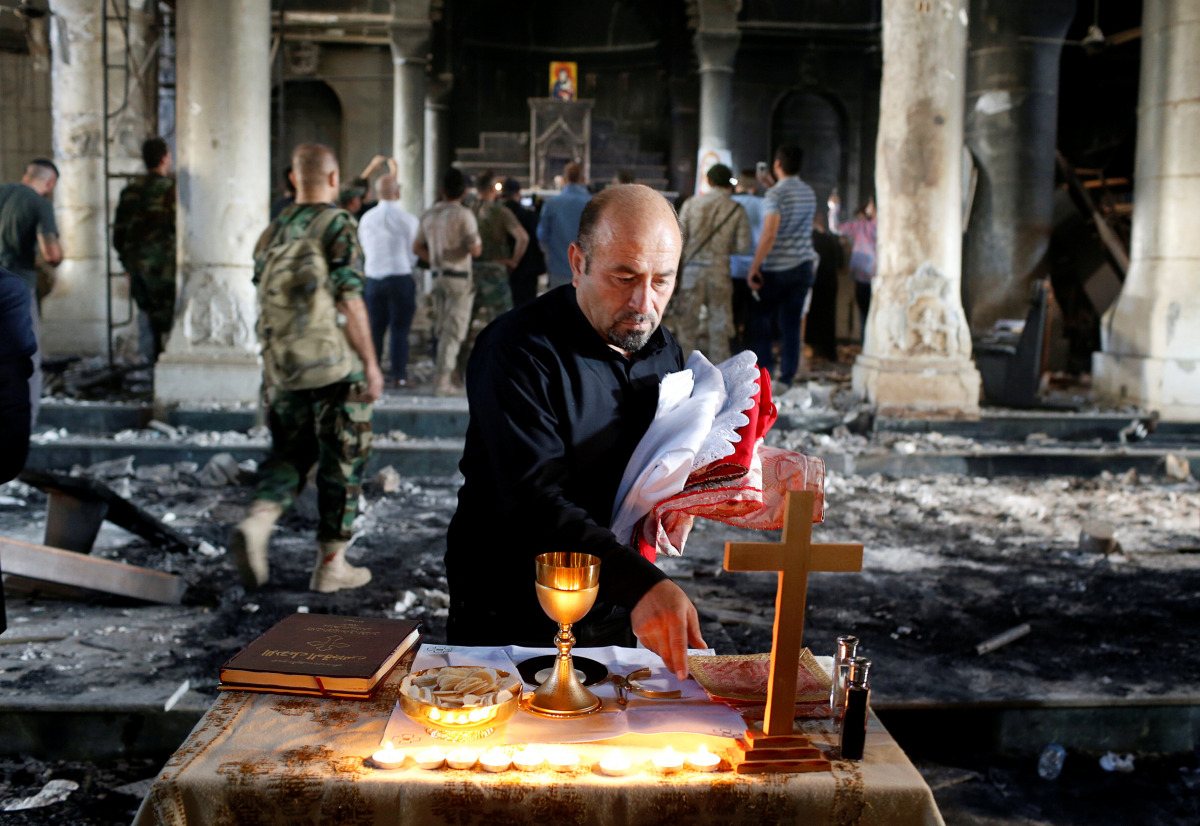 An Iraqi Christian prepares for the first Sunday mass at the Grand Immaculate Church since it was recaptured from Islamic State in Qaraqosh, near Mosul in Iraq October 30, 2016. REUTERS/Ahmed Jadallah