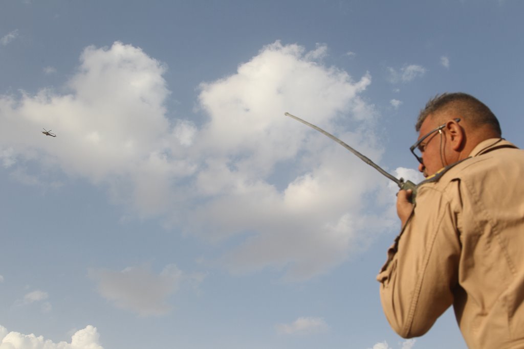 An Iraqi officer uses a radio to communicate with the crew of a helicopter during an operation against Islamic State militants south of Mosul, Iraq October 30, 2016. REUTERS/Stringer