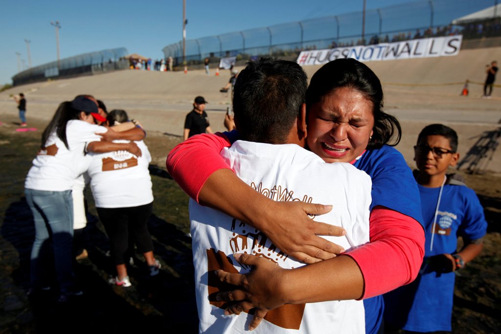 Relatives separated by deportation and immigration hug at the border during a brief reunification meeting at the banks of the Rio Bravo, a natural border between U.S. and Mexico, October 29, 2016. REUTERS/Jose Luis Gonzalez/File Photo
