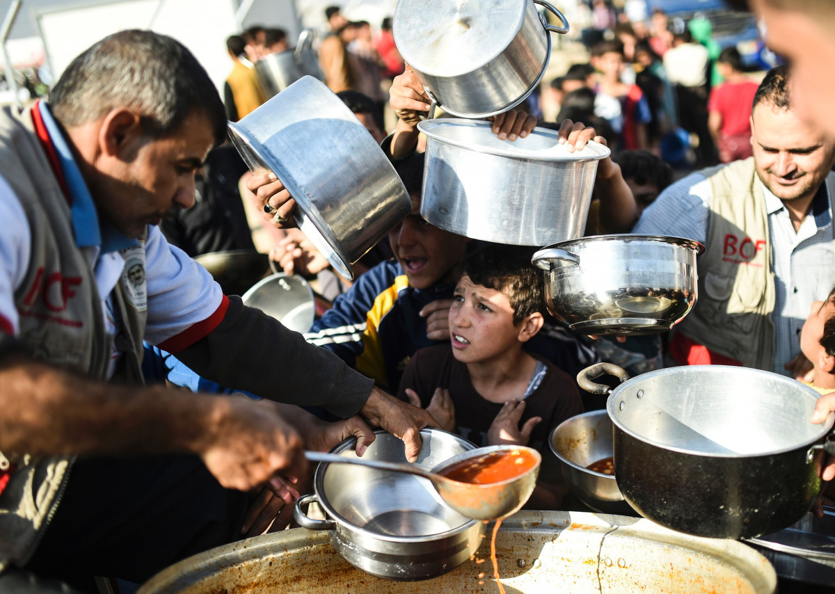 Displaced Iraqi boys wait to receive food at a refugee camp in the Khazir Region, between Arbil and Mosul on November 5, 2016. Aid workers have warned of a major humanitarian crisis when fighting begins in earnest for Mosul, which is home to more than a m