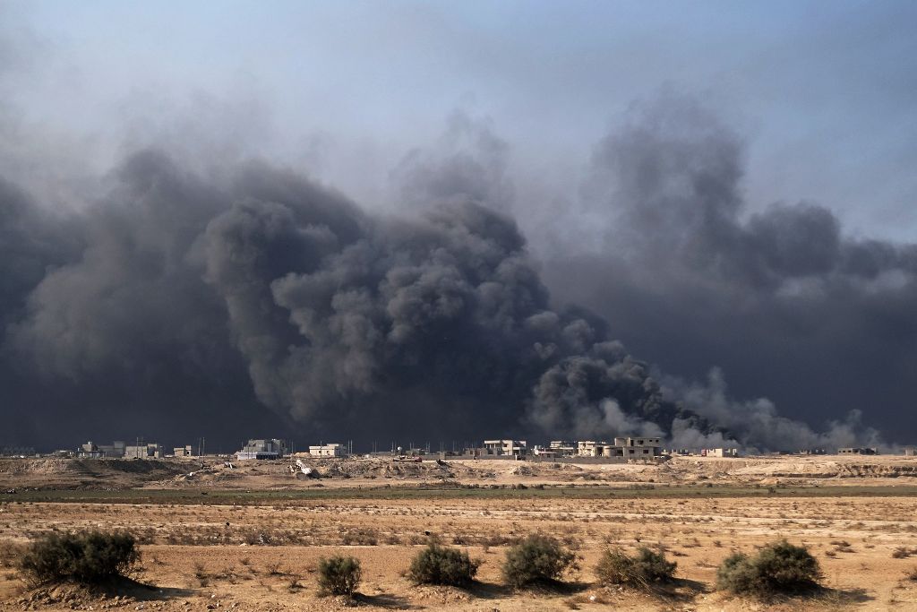 Smoke rises from burning oil wells in Qayyarah, south of Mosul, on November 4, 2016, during operation by Iraqi forces to retake the main hub city from the Islamic State (IS) group jihadists. Elite Iraqi forces pushed deep into the streets of Mosul on Frid