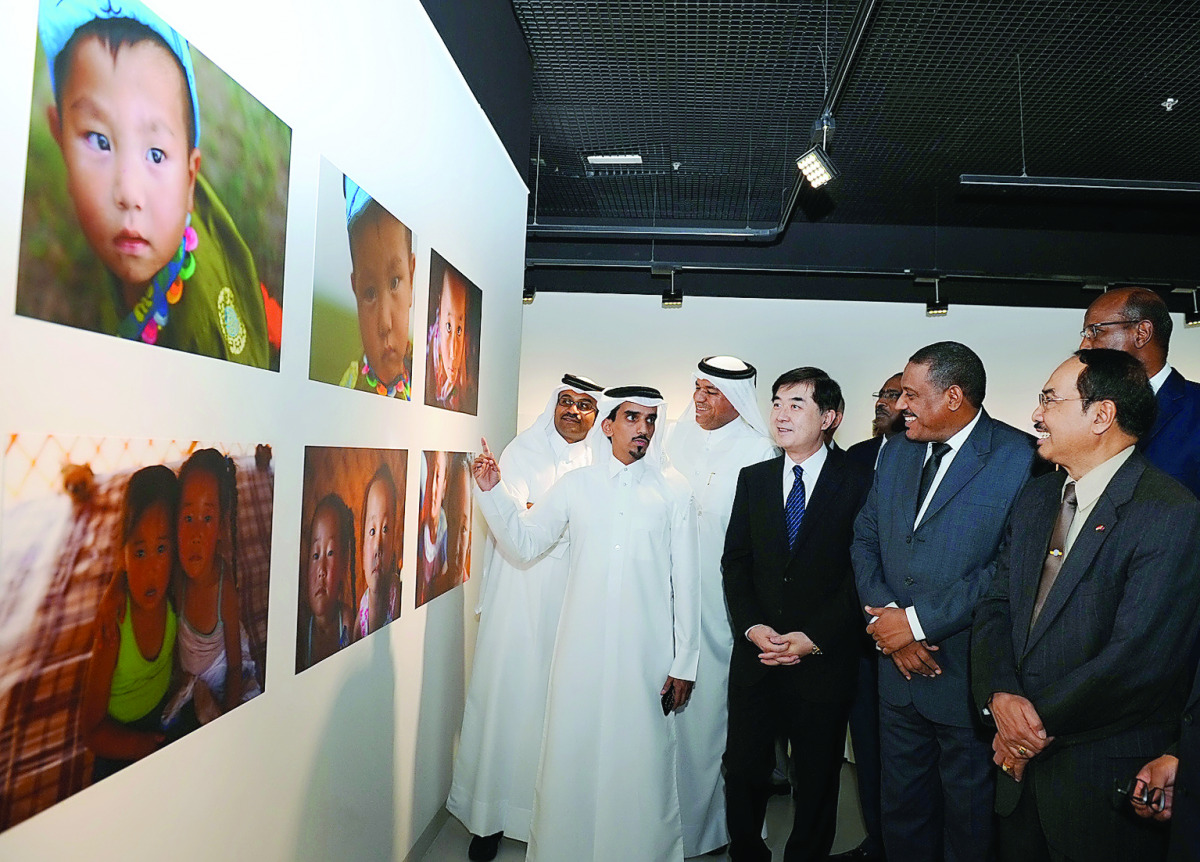 The Ambassador of China to Qatar, Li Chen; Director of Arts in Residence, Fire Station, Khalifa Ahmed Al Obaidly; and other diplomats viewing the photography exhibition 