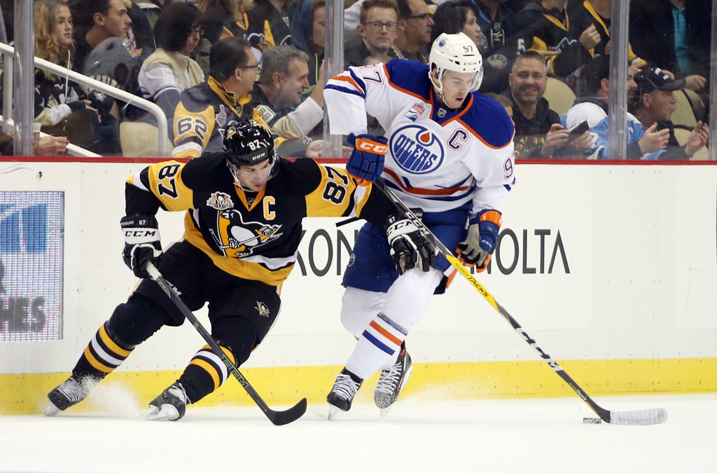 Edmonton Oilers center Connor McDavid (97) controls the puck against Pittsburgh Penguins center Sidney Crosby (87) during the first period at the PPG Paints Arena. Charles LeClaire-USA TODAY Sports
