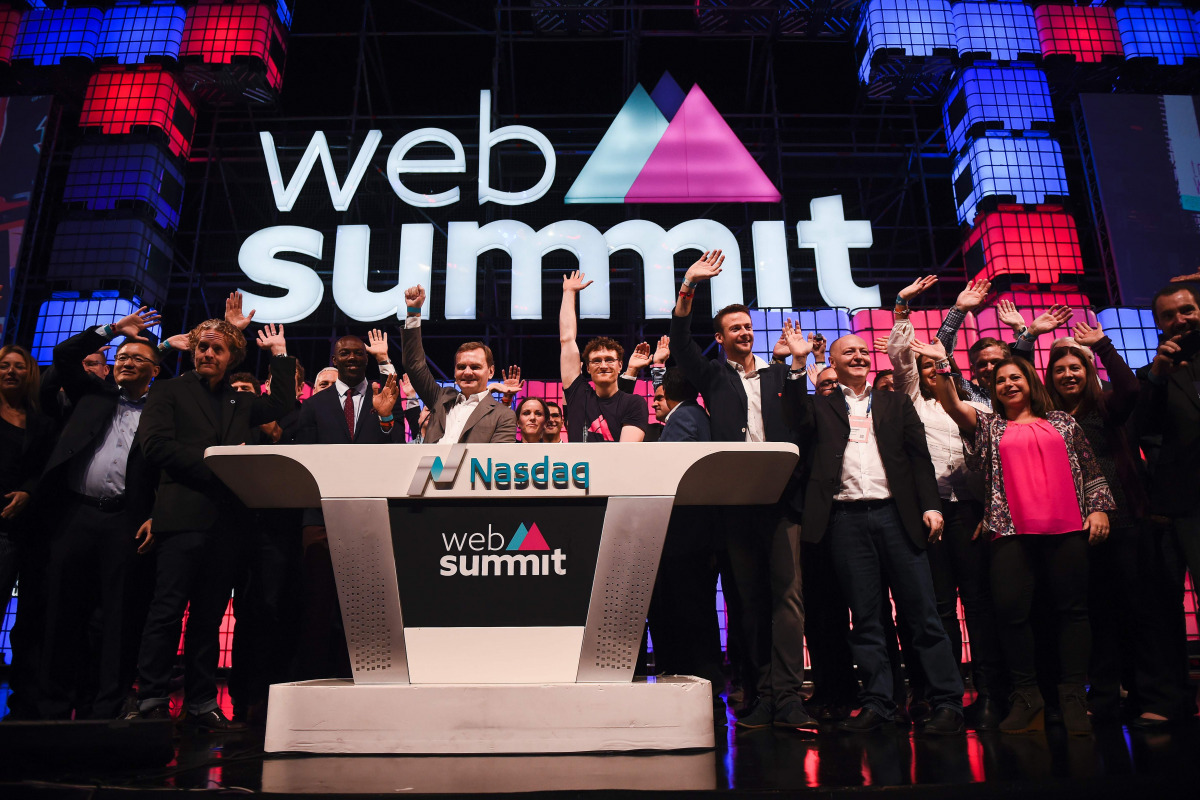 Irish founder & CEO of Web Summit Paddy Cosgrave (CR with eyeglasses) and other participants wave during the Nasdaq Bell opening ceremony at the main stage of the Web Summit at Parque das Nacoes, in Lisbon on November 9, 2016. Europe's largest tech event 