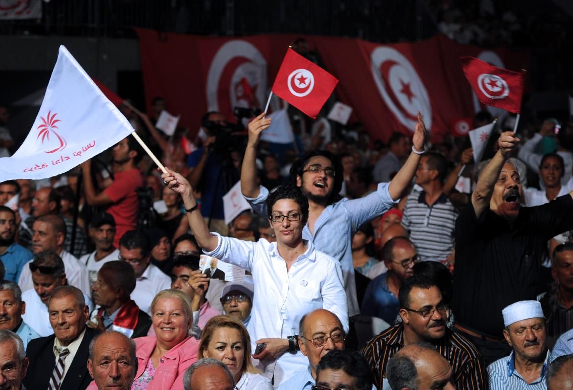People wave Tunisian and 