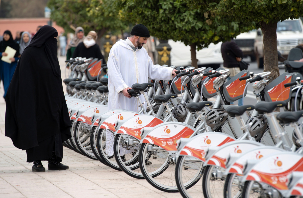 Morrocans inspect the recently installed Bicycle sharing system, known as 