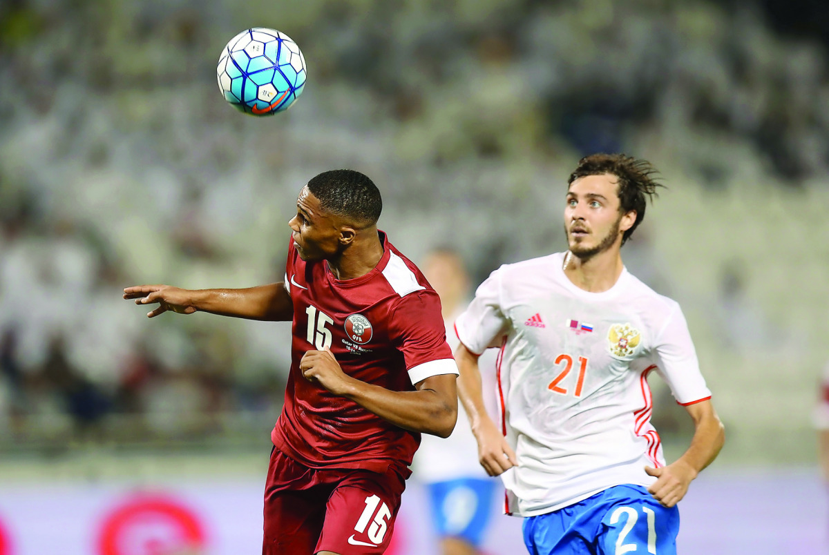 Qatar's Pedro Miguel (left) heads the ball while Russia's Aleksandr Kokorin looks on during their international friendly match played at Al Sadd SC Stadium
