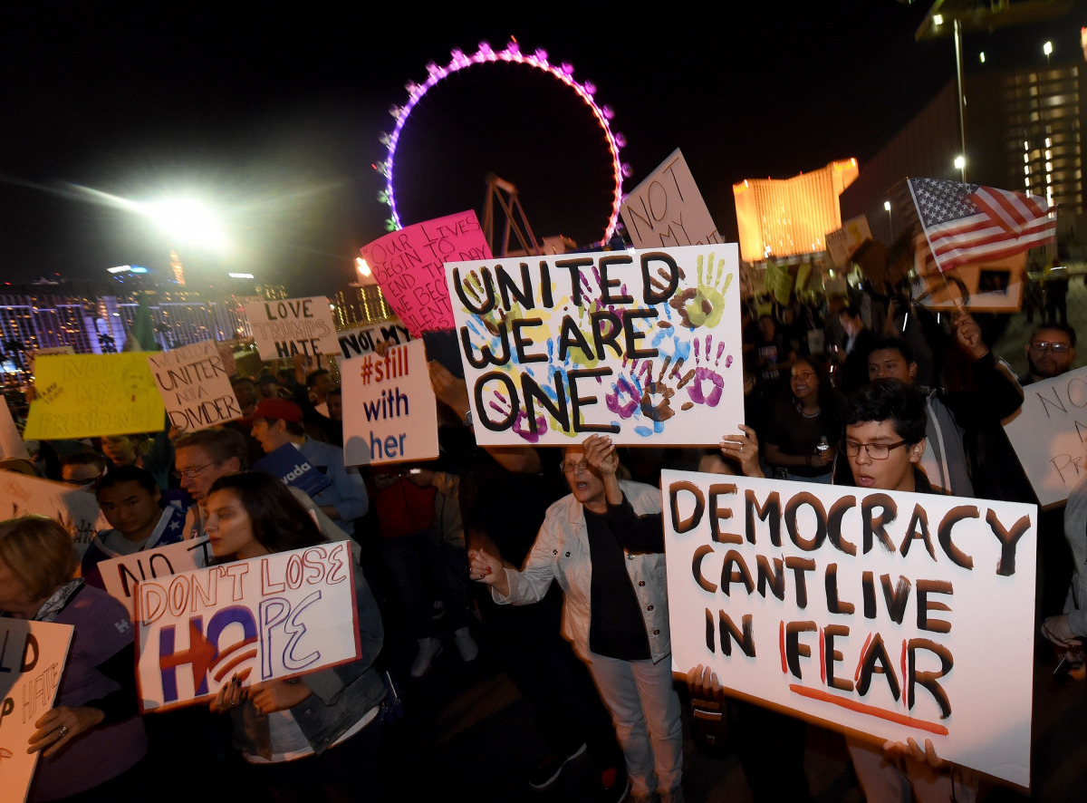 Anti-Donald Trump protesters hold signs as they gather at The Linq Promenade before marching on the Las Vegas Strip on November 12, 2016 in Las Vegas, Nevada. The election of Trump as president has sparked protests in cities across the country. (Ethan Mil