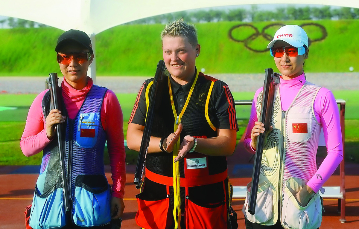 Katrin Quooss (centre) of Germany, gold medal winner in the Shotgun Trap event at the 49th CISM World Military Shooting Championship poses for a picture along with Wand Jinglin of China and Wand Yajun of China, bronze and silver medal winners.