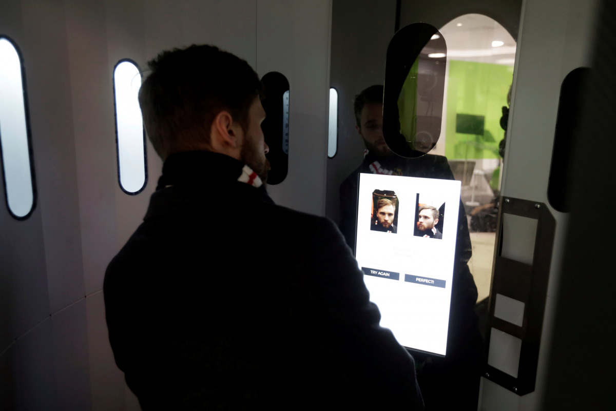 A man takes a picture of himself in the egg-shaped 3D virtual reality photo booth in Tallinn, Estonia November 8, 2016. Picture taken November 8, 2016. REUTERS/Ints Kalnins