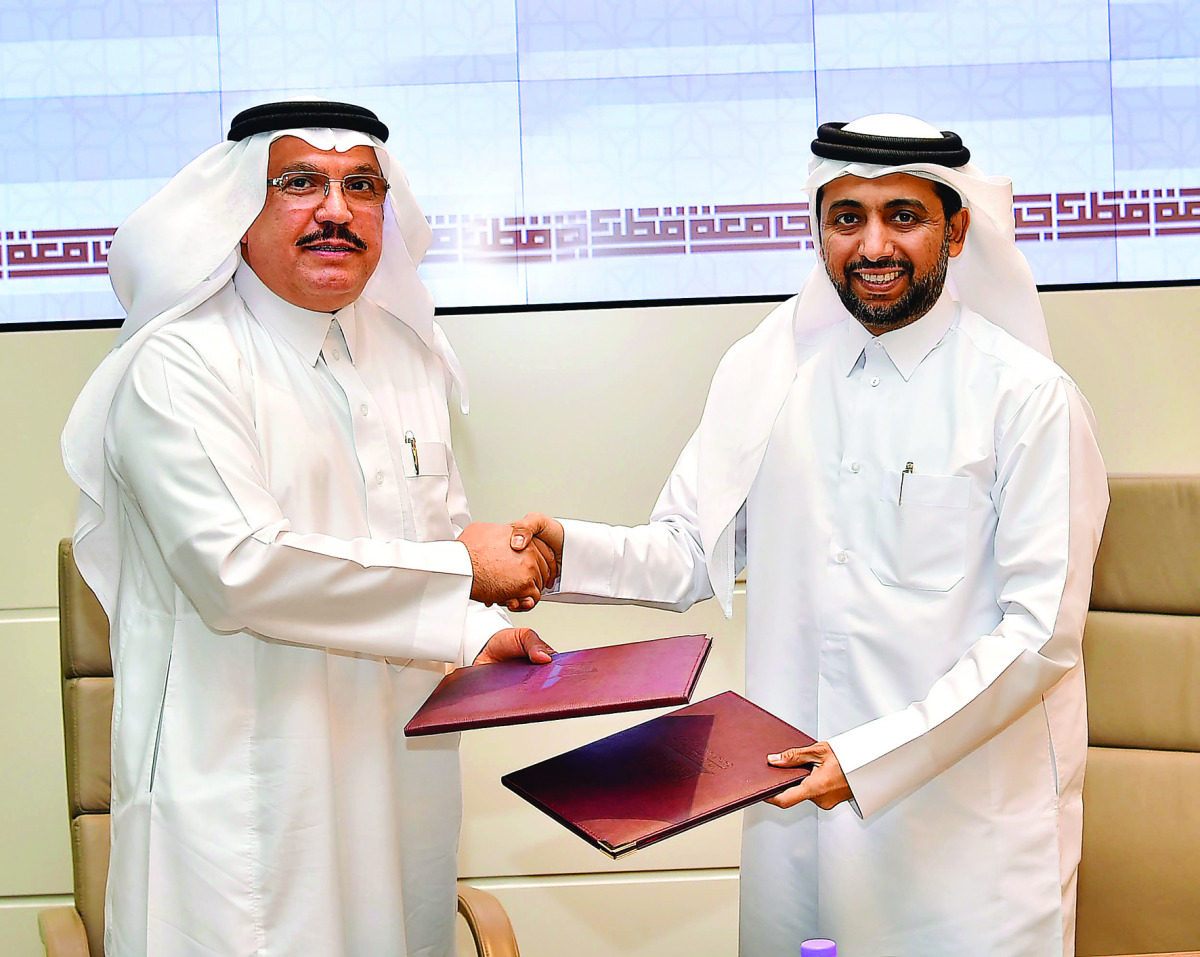 QU President Dr Hassan Al Derham and GOIC Secretary-General Abdul-Aziz H Al Ageel after signing the deal.