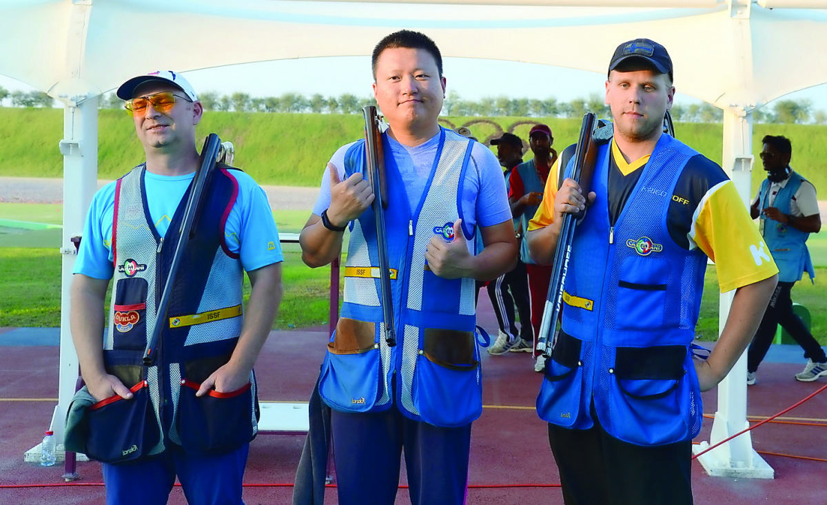 Ying Xu of China (centre) winner in the individual Skeet event at the 49th CISM World Military Shooting Championship poses for a picture along with silver medallist Jan Sychra of Czech Republic and Oskari Kossi of Finland at Losail Shooting Range yesterda