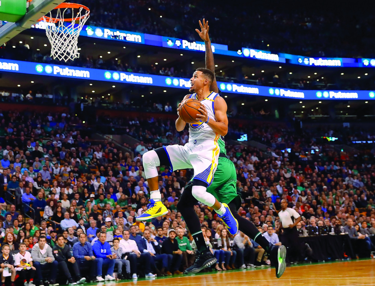 Golden State Warriors guard Stephen Curry (30) drives to the basket against the Boston Celtics during their NBA game at TD Garden, in Boston, Massachusetts, US, on Saturday.