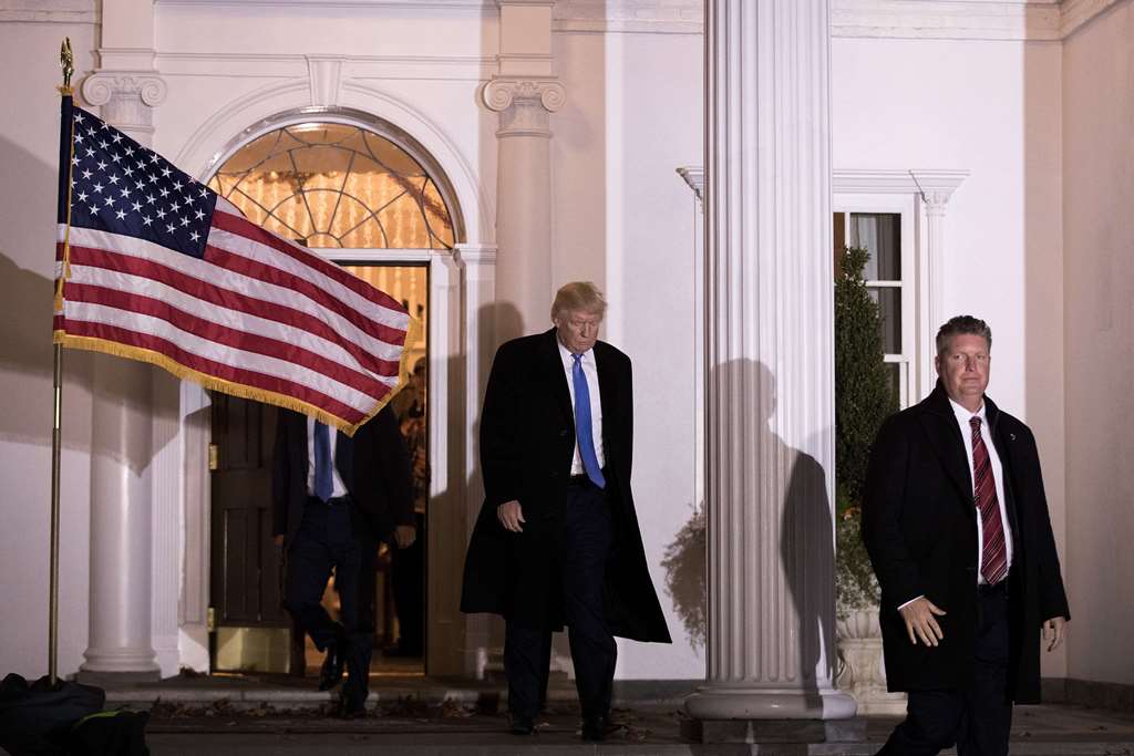 BEDMINSTER TOWNSHIP: Flanked by U.S. Secret Service agents, President-elect Donald Trump leaves the clubhouse following a full day of meetings at Trump International Golf Club, November 20, 2016 in Bedminster Township, New Jersey. Drew Angerer/Getty Image