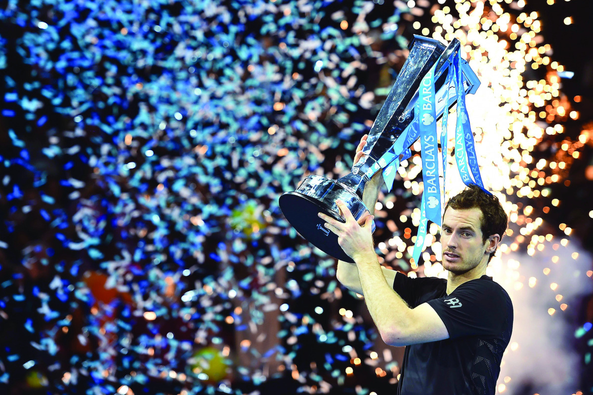 Andy Murray celebrates with the trophy after winning the men's singles final against Novak Djokovic of the ATP World Tour Finals tennis tournament in London on Sunday.