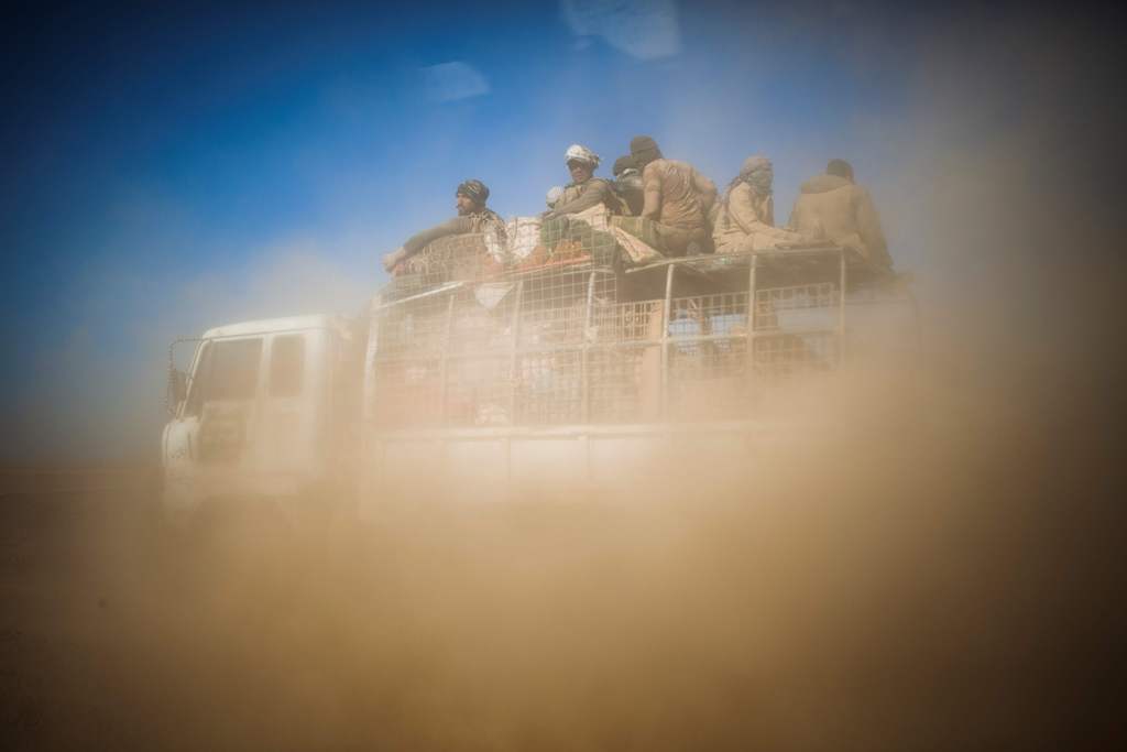 Members of the Hashd Al Shaabi (Popular Mobilisation Units) are seen through a car window, aboard a truck on their way to Tal Afar airport on November 20, 2016.   AFP / Achilleas Zavallis
