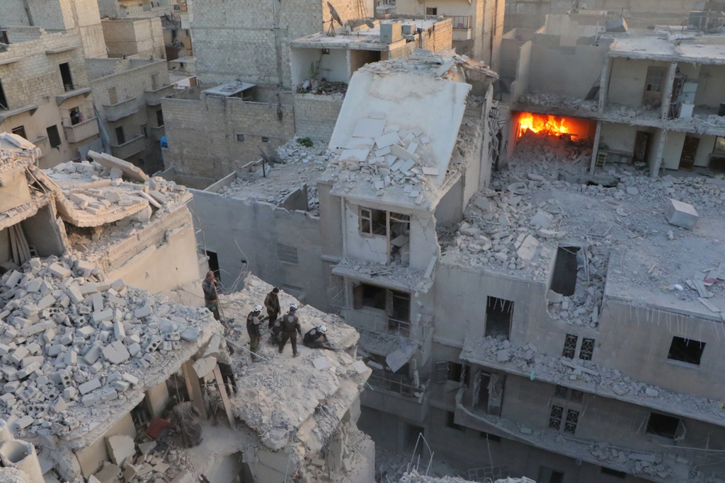 Search and rescue team members work at the scene of the air strikes carried out by the war crafts belonging to Assad regime forces on the opposition-controlled Al Moyaser neighbourhood of Aleppo, Syria on November 22, 2016.( ?brahim Ebu Leys - Anadolu Age