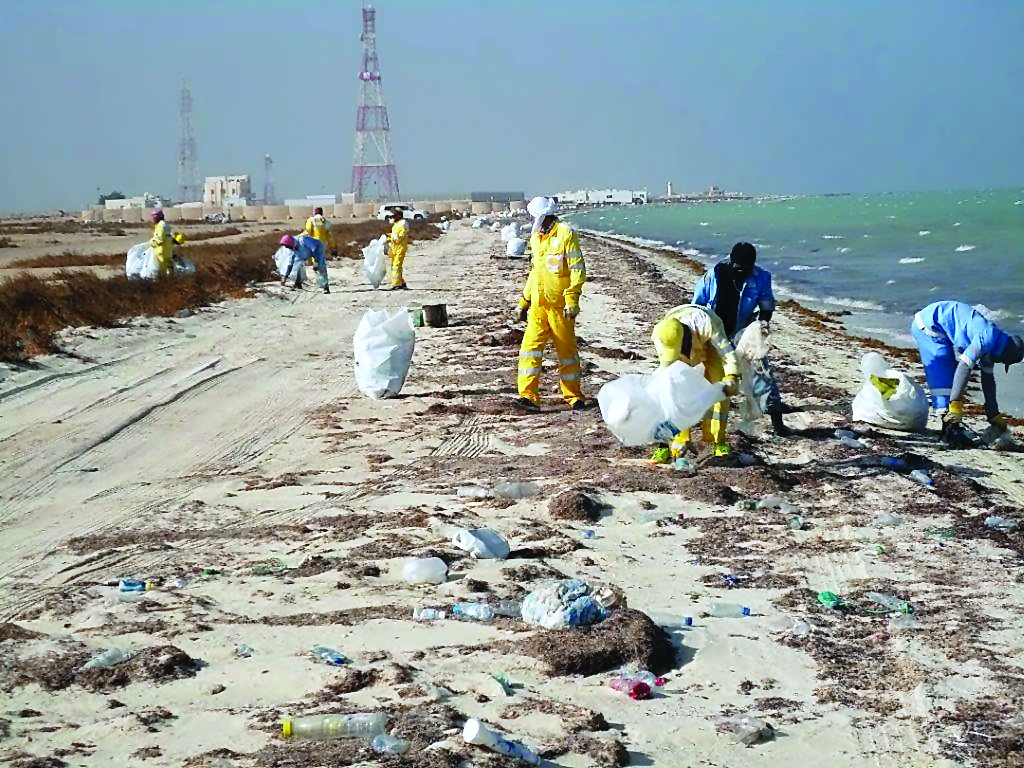 Trash being removed from a beach in Qatar. 