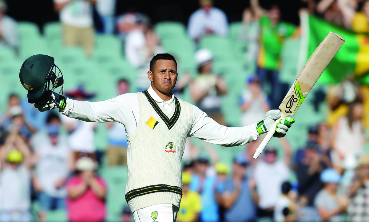Australian batsman Usman Khawaja celebrates after scoring a century against South Africa during the second day of the Third Test in Adelaide yesterday