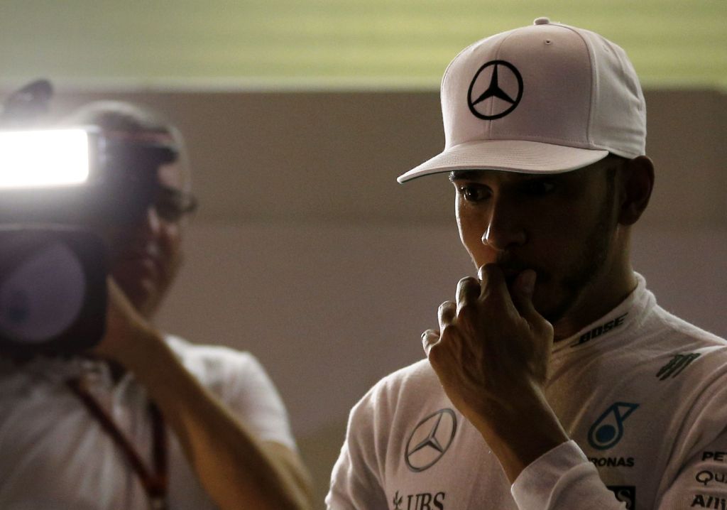 Mercedes AMG Petronas F1 Team's British driver Lewis Hamilton walks out of the garage after the second practice session as part of the Abu Dhabi Formula One Grand Prix at the Yas Marina circuit on November 25, 2016. / AFP / Karim Sahib
