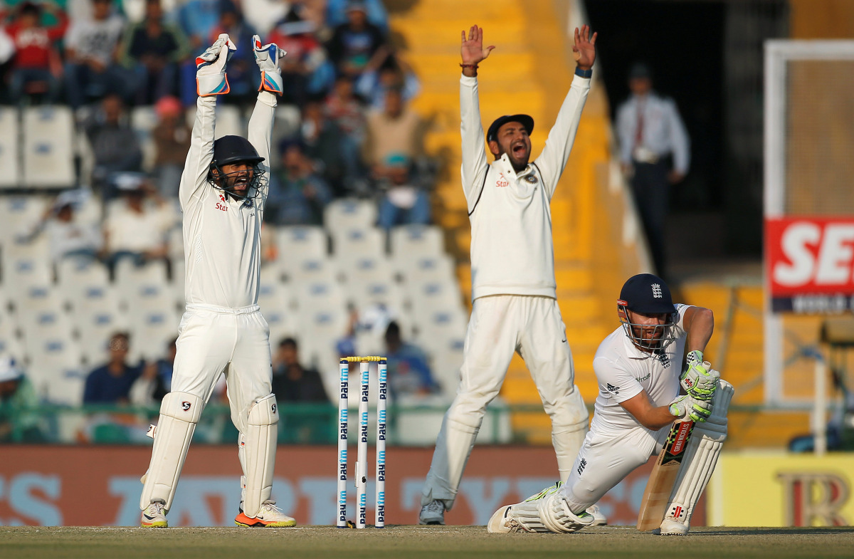 India's Parthiv Patel (L) and Cheteshwar Pujara successfully appeal for the dismissal of England's Jonny Bairstow. (REUTERS/Adnan Abidi)