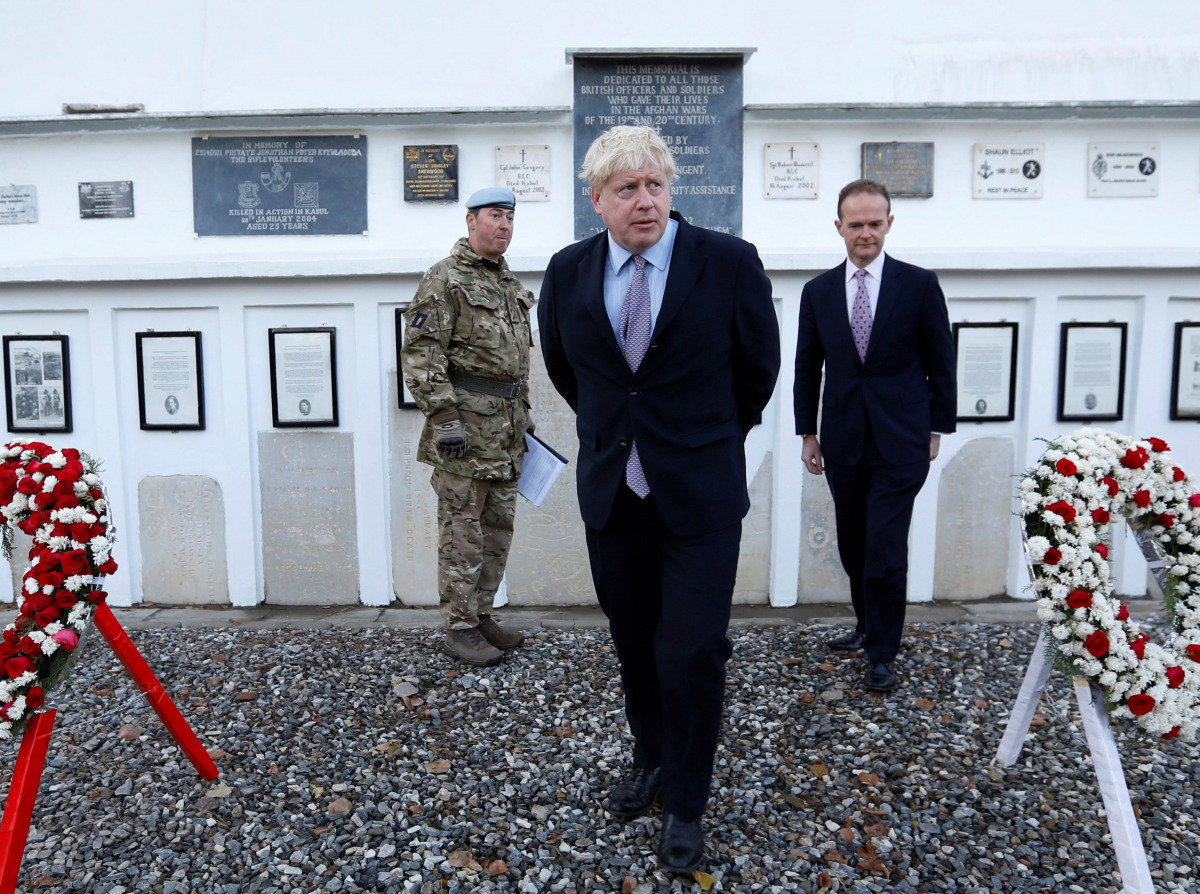 Britain's Foreign Secretary Boris Johnson (C) and British ambassador to Afghanistan Dominic Jermey (R) visit the British cemetery in Kabul, Afghanistan November 26, 2016. REUTERS/Mohammad Ismail