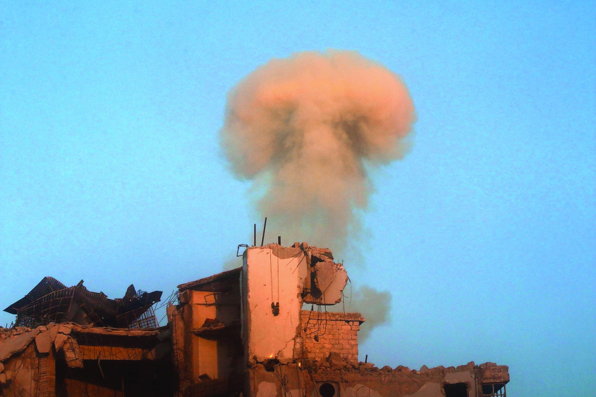 Smoke rises from a damaged building after a strike on the rebel-held besieged Al Shaar neighbourhood of Aleppo, Syria, yesterday.