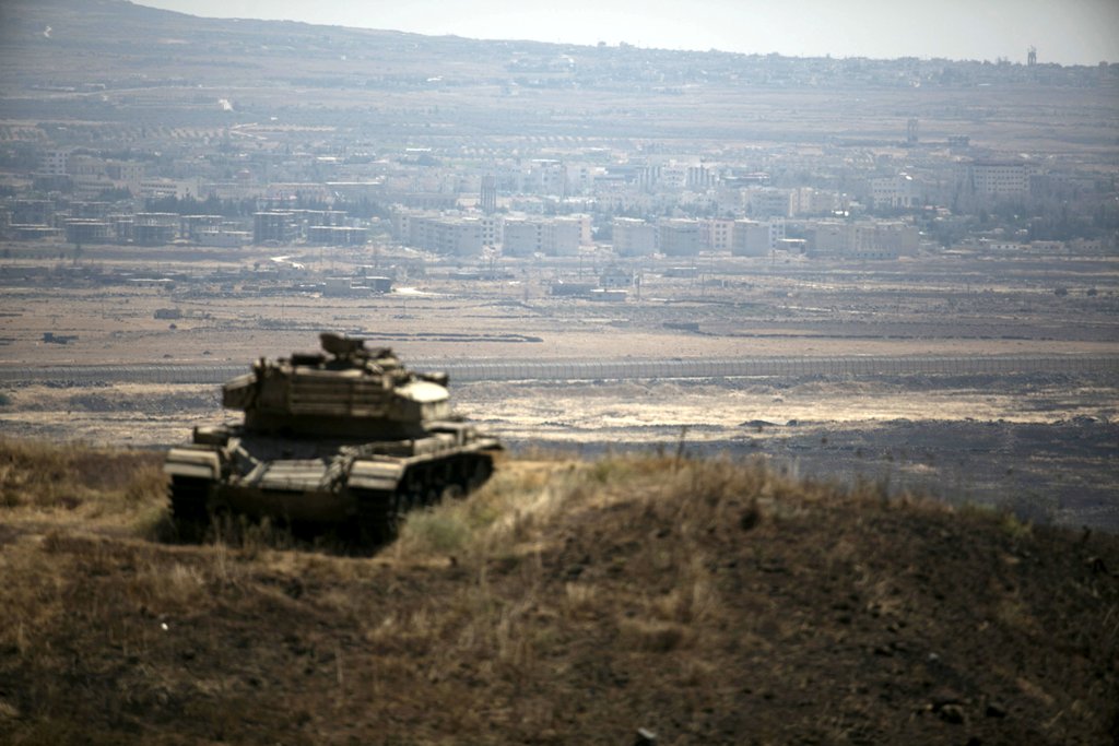 FILE PHOTO: The Syrian area of Quneitra is seen in the background as an out-of-commission Israeli tank parks on a hill, near the ceasefire line between Israel and Syria, in the Israeli-occupied Golan Heights, August 21, 2015. REUTERS/Baz Ratner/File Photo