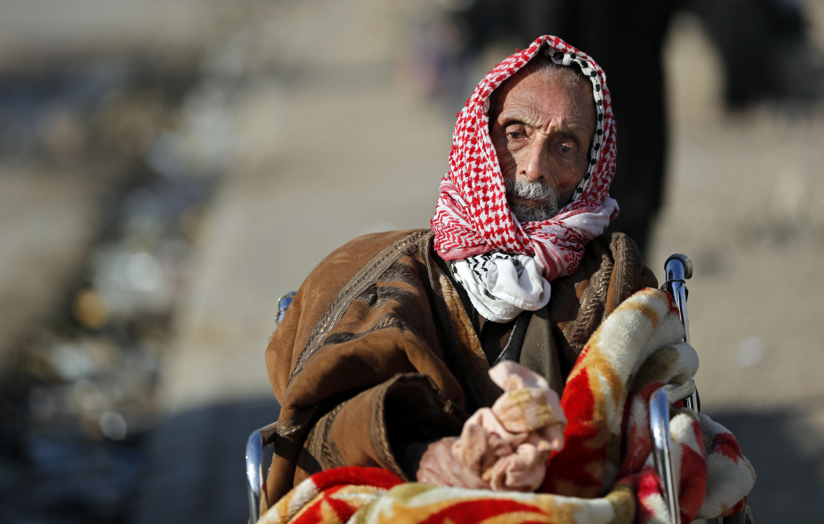 A displaced Iraqi man, who fled his home, waits to be transferred to a camp, on November 28, 2016 in the village of Gogjali, on the eastern edge of Mosul, during the ongoing figthing between Islamic State (IS) group jihadists and government forces. Some 7
