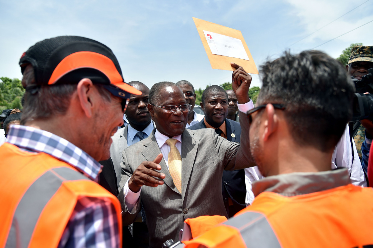 This file photo taken on July 29, 2016 shows Haitian Provisional President, Jocelerme Privert (C), attending the dedication of a new bridge for the Route Soleil 9, at the Cite Soleil neighborhood of Port-au-Prince. Haiti's interim leader Jocelerme Privert